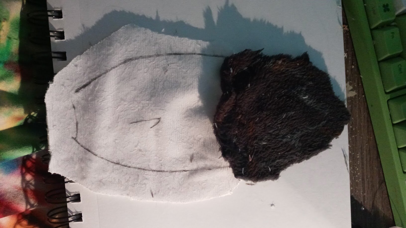 one of the tail halves flipped over to show the somewhat-roughly-cut edge between the white and black bits.