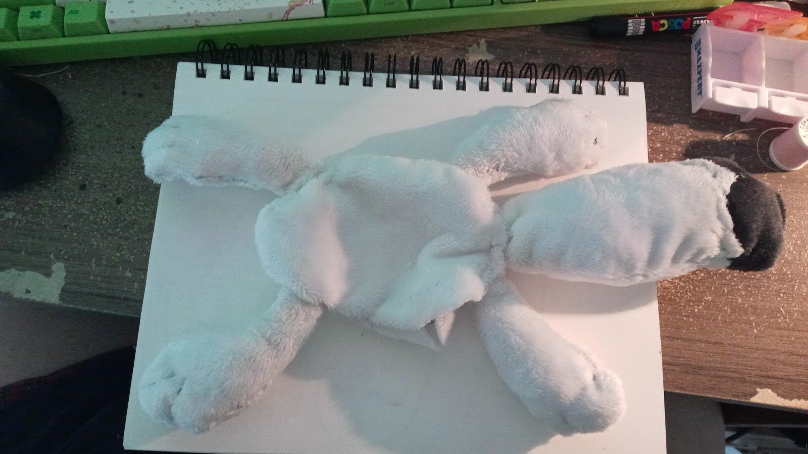 the plush turned inside out, with all limbs and tail attached. it is headless.